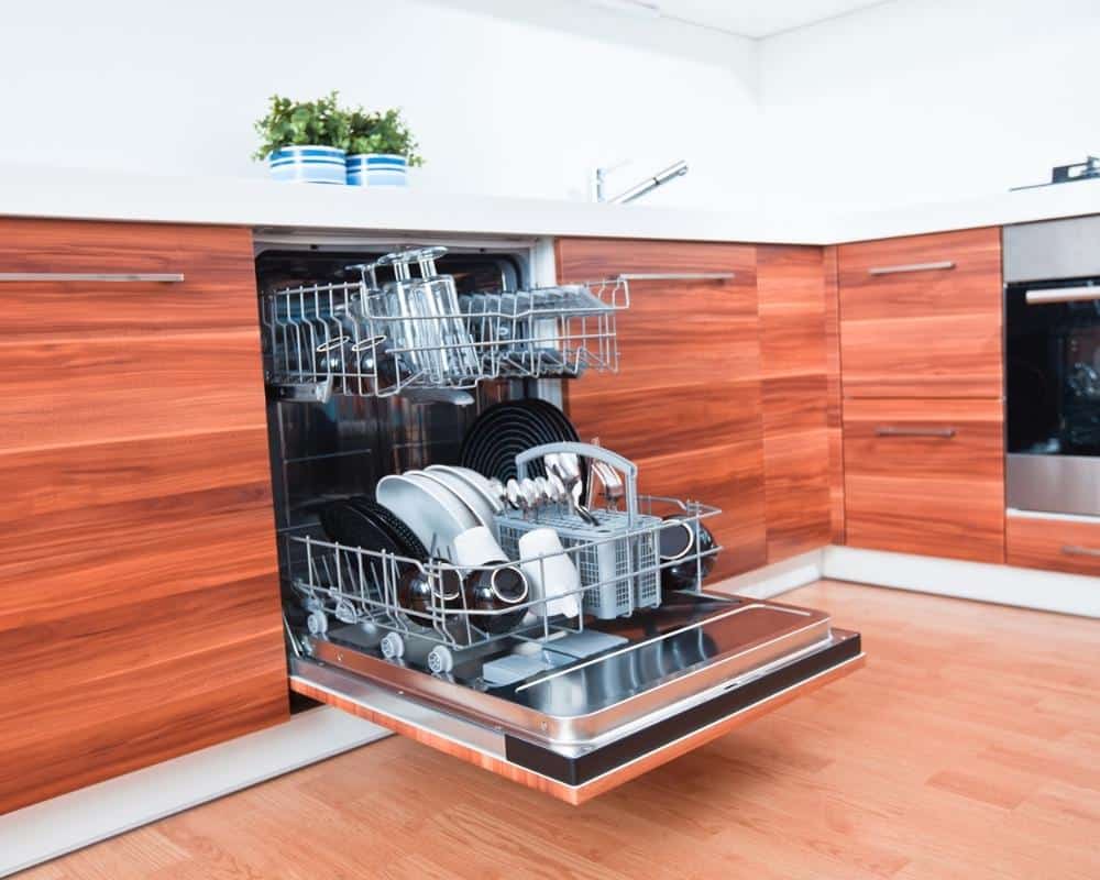 A dishwasher with the door open that's full of clean dishes.